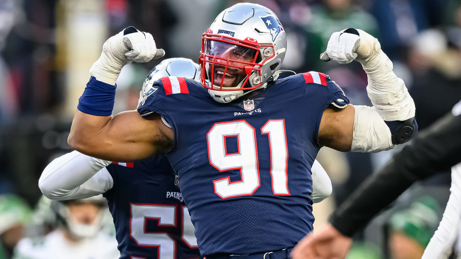 New England Patriots' Marcus Jones runs back a punt for the