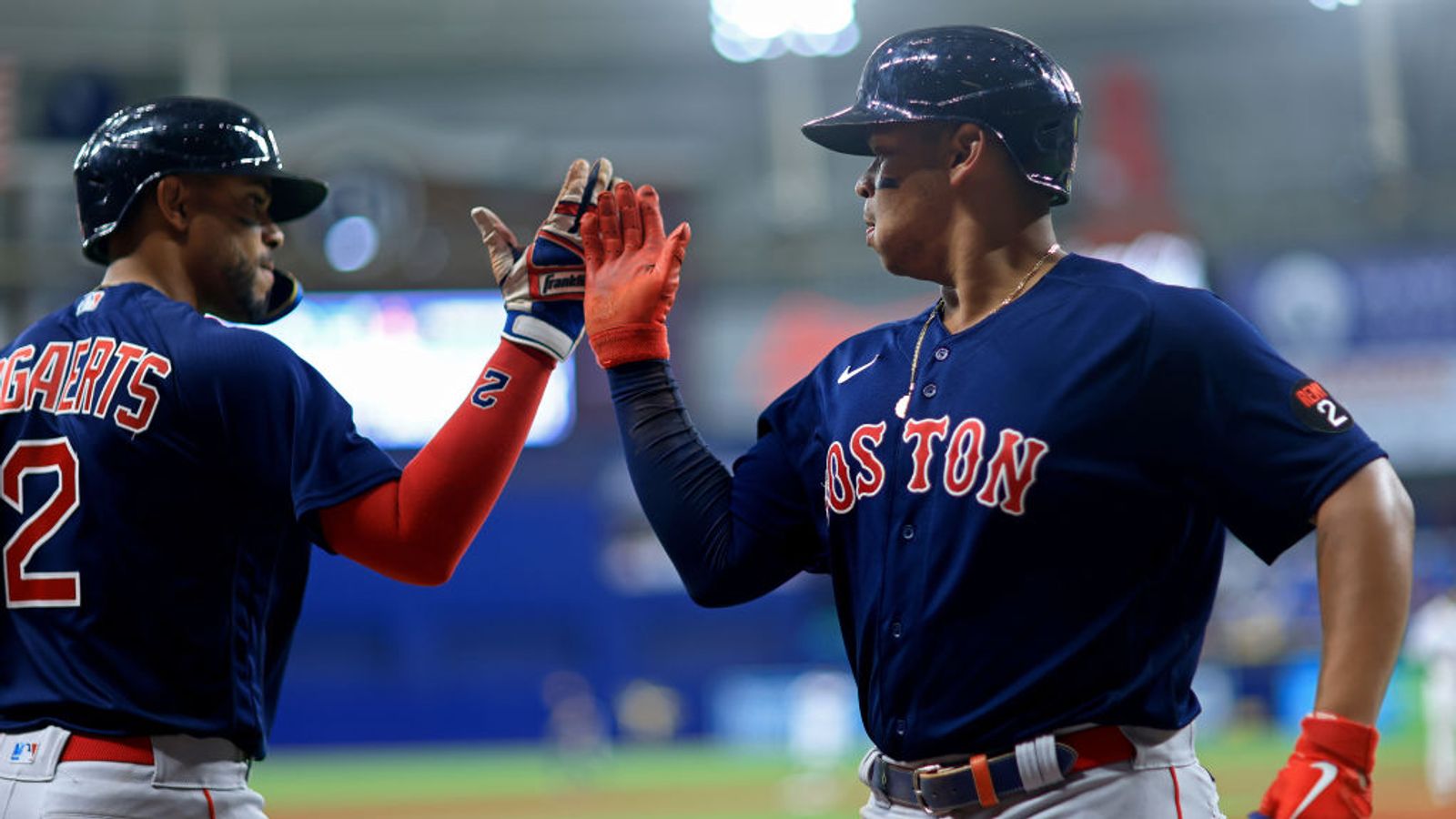 Trevor Story of the Boston Red Sox high-fives Rob Refsnyder after