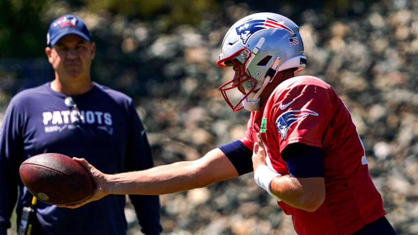 Here's why some Patriots players are wearing caps over their helmets during  training camp